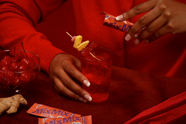 Ginger drink stick mix being poured into glass