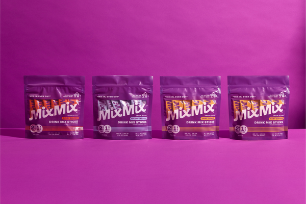 Five packages of Mixmix drink mix on a purple background