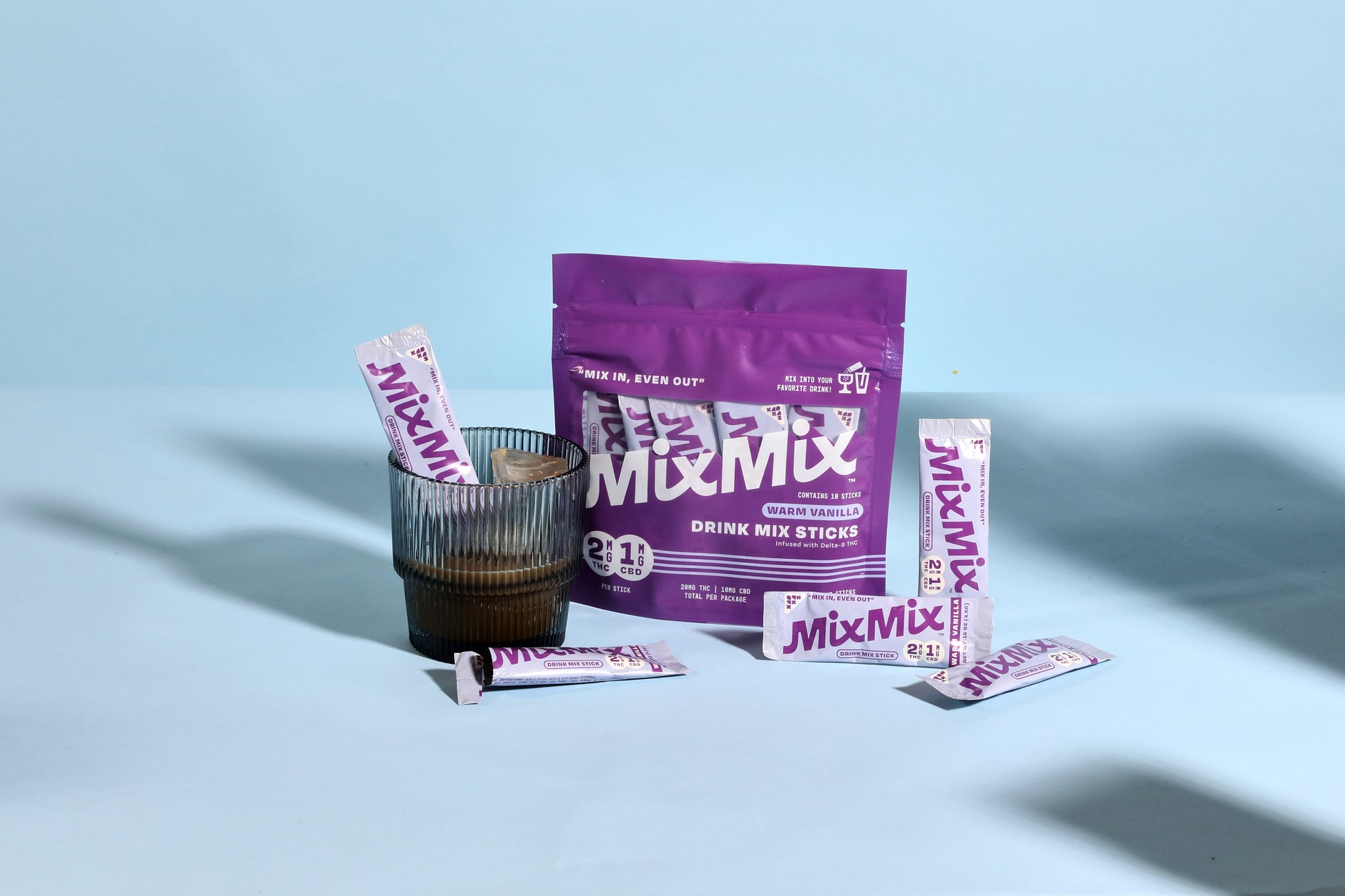 MixMix drink mix packaging and sticks on a light blue background